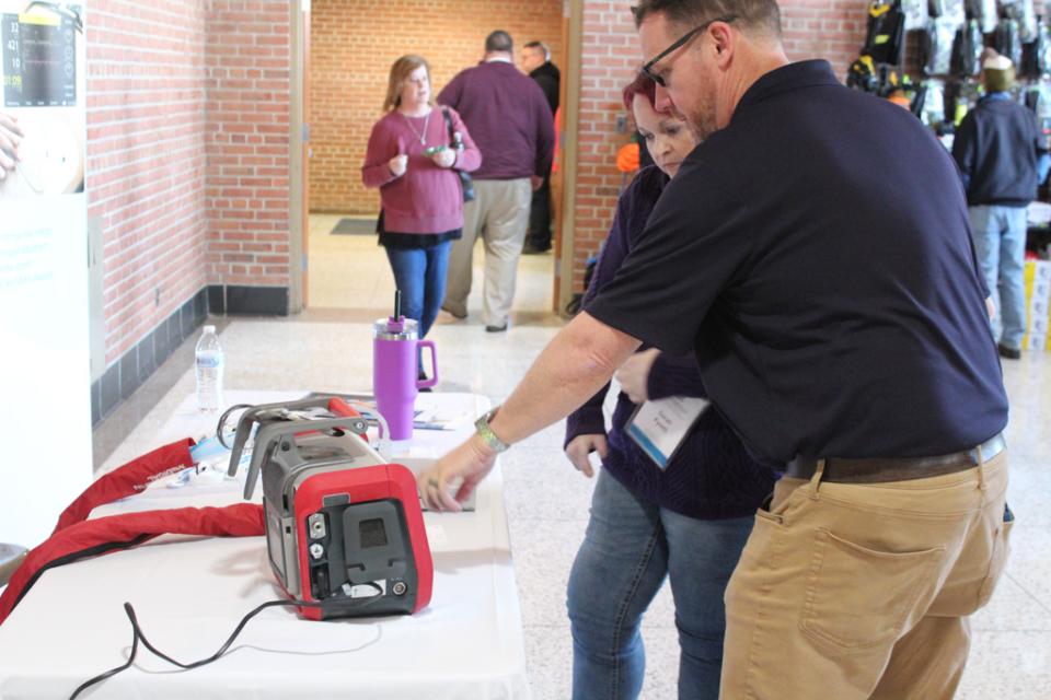 Participant sees demonstration of automated CPR device during a break time at Winterfest 2024.