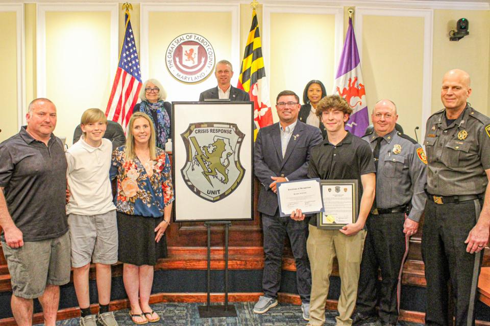 Council Member Dave Stepp presented to Blake Newton (third from right) for his logo design. He was joined his family, Easton Police Department Chief Alan Lowery, and Talbot County Sheriff Joe Gamble.