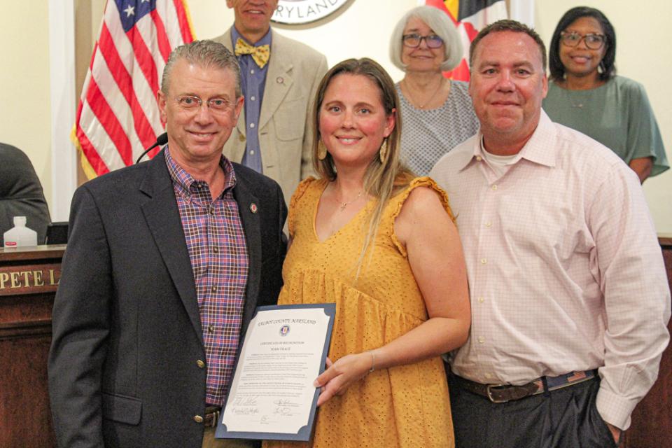 Council President Chuck Callahan presents Nicole and Dereck Janes, representing Team Trace, with a Certificate of Recognition.