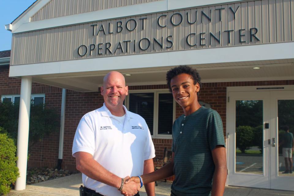Matt Watkins, EMS Division Chief at Department of Emergency Services, shakes hands with Geovanni Greaves, rising Senior at St. Michaels Middle High and new apprentice for Emergency Services.
