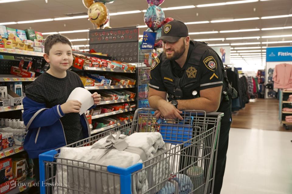 Deputy First Class D. Scrivener of Talbot County Sherriff&#039;s Office does some holiday shopping alongside his partner at Walmart in Easton for the Talbot Optimist&#039;s &#039;Shop with a Cop&#039; event.
